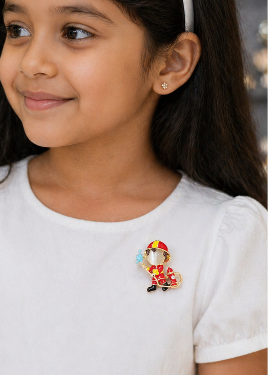 Young girl wearing a colorful fireman brooch on a plain background