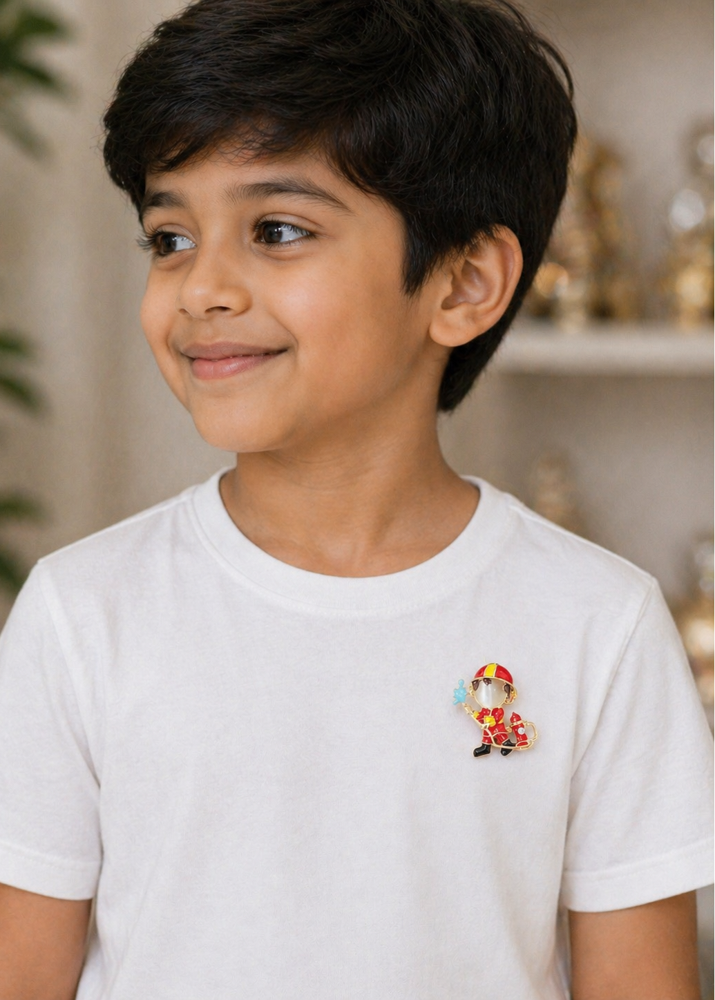 Young boy wearing a white t-shirt with a colorful fireman brooch
