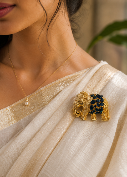 Royal Blue Elephant Brooch worn on a cream saree