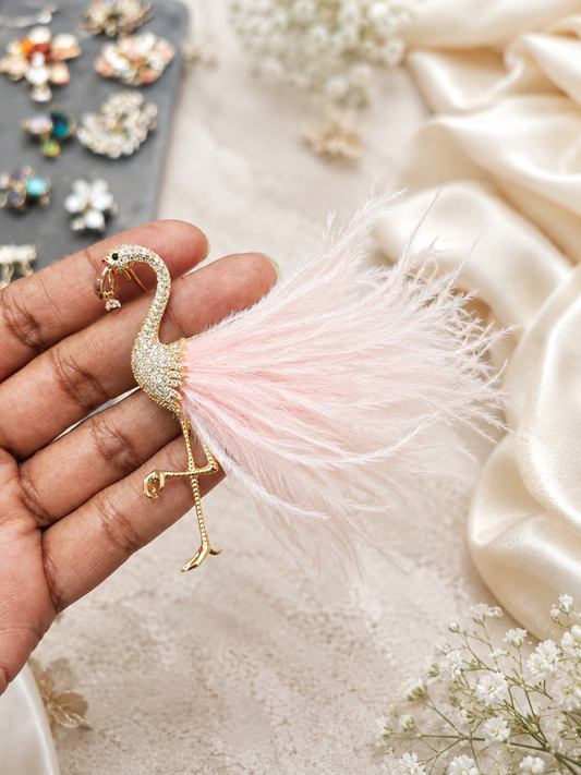 Blush Plume Flamingo Brooch shown close up in hand