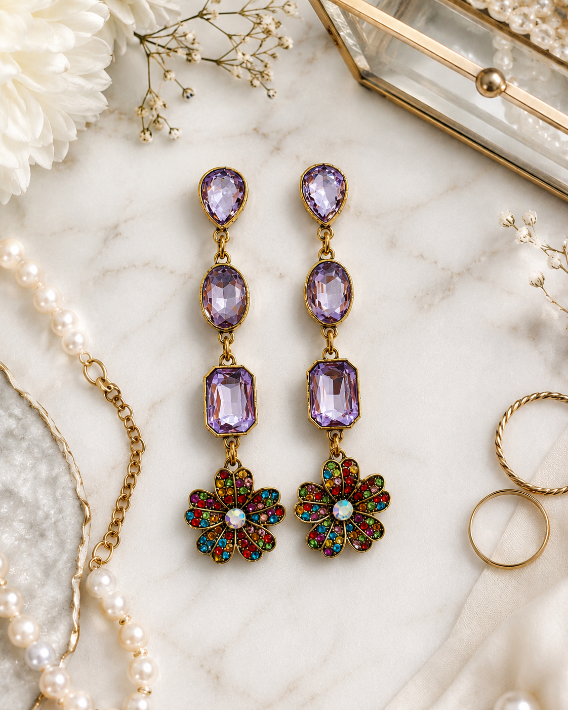 Lavender floral AD stone dangle earrings in a detailed flat lay