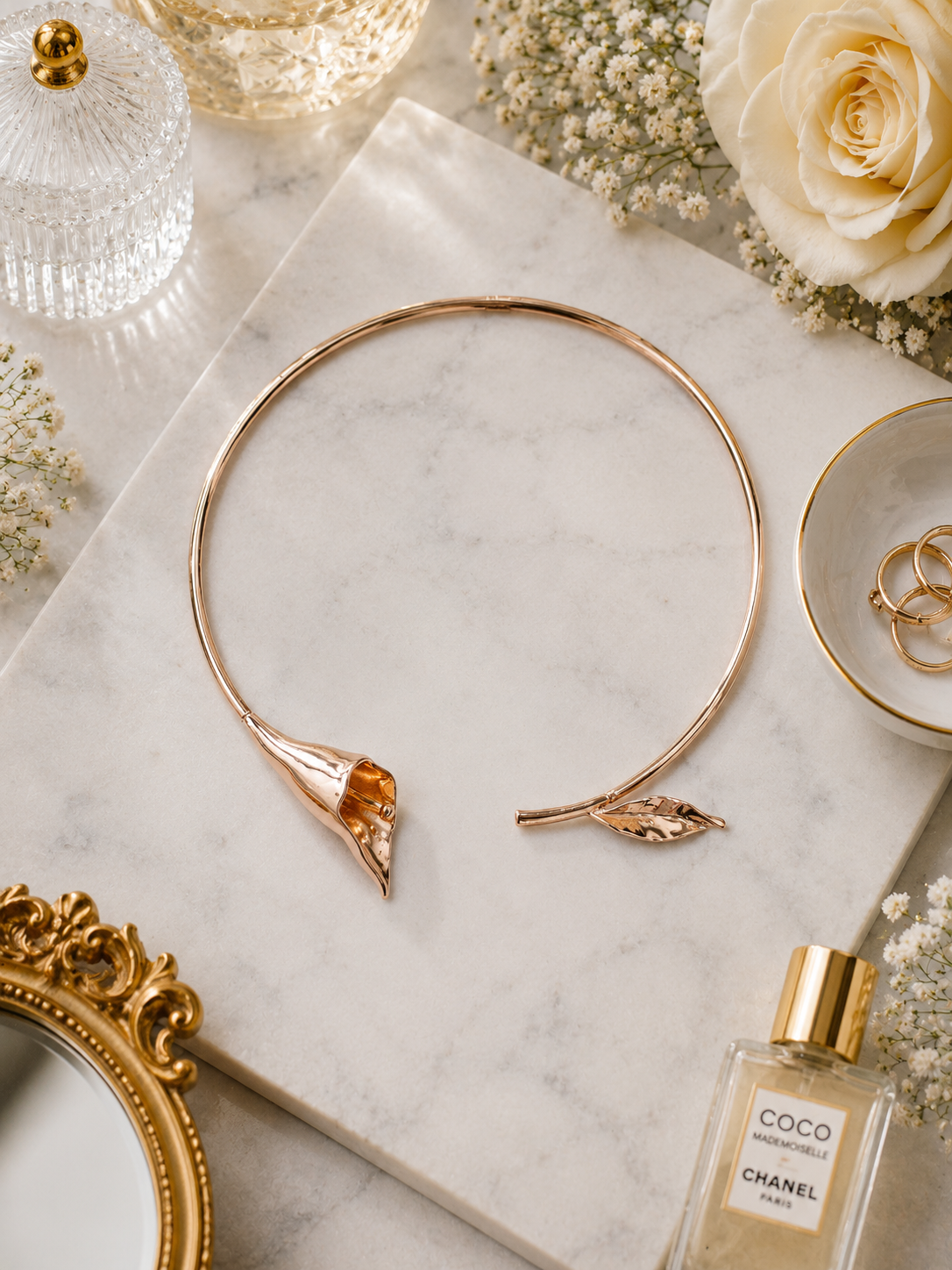 Calla-lily and leaf open choker necklace shown in a flat lay