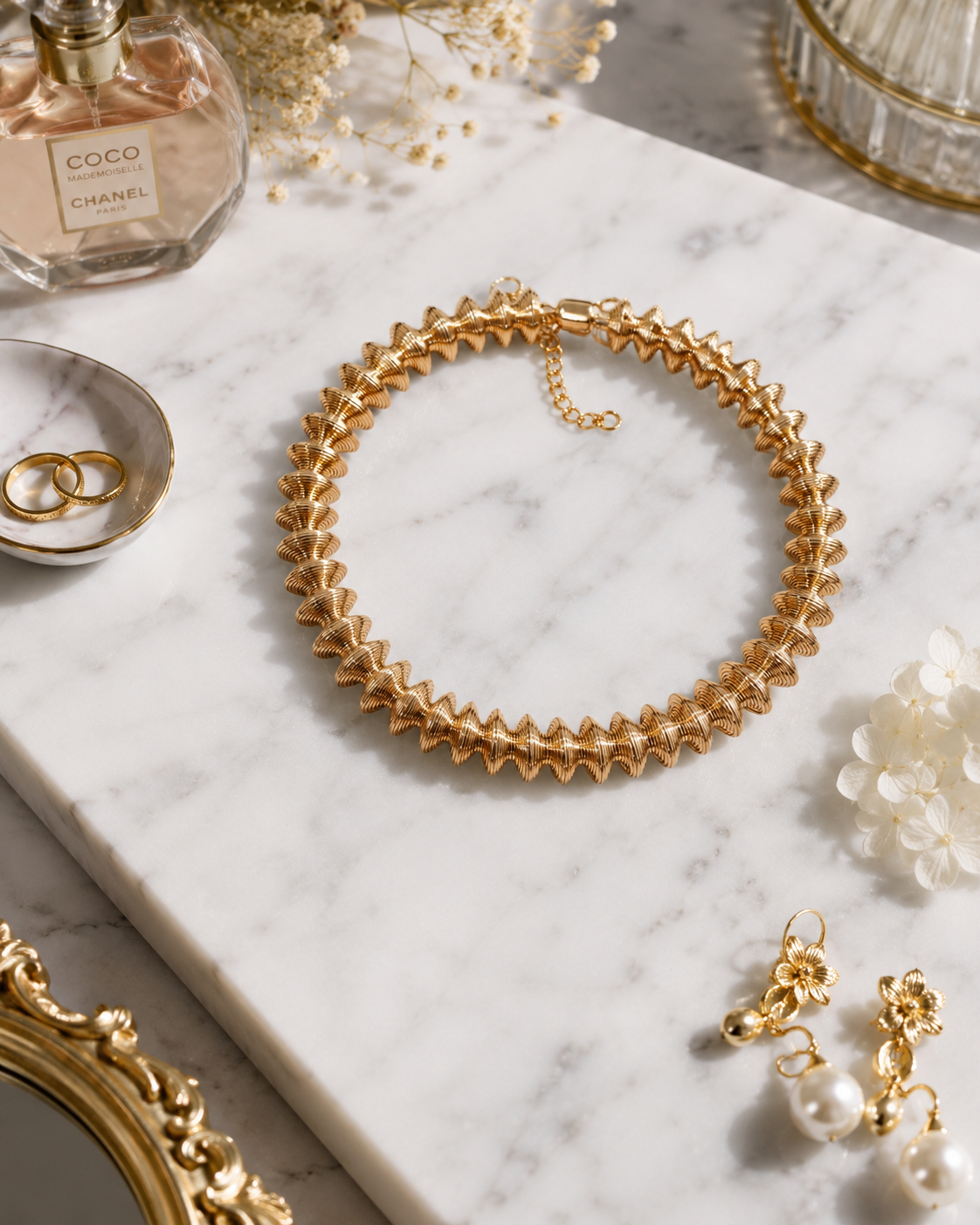 Golden Laurel Statement Necklace shown in a styled flat lay