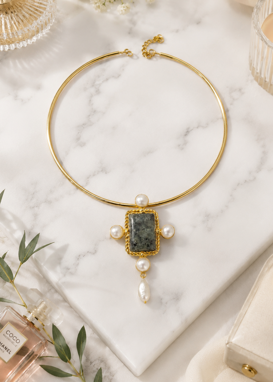 Celeste Stone Hasli with natural semi-precious green stone, pearl accents and polished gold finish displayed on a marble surface.