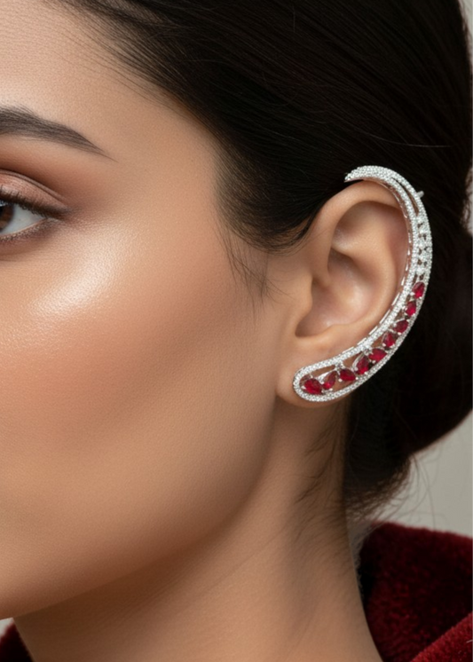 Close-up of Celeste Red Stone Ear Cuff with sparkling red stones and silver-tone finish