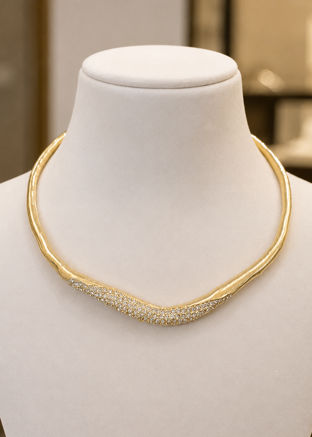 Luna Gold Crystal Hasli Necklace displayed on a jewelry bust featuring a contemporary gold-tone design with sparkling crystal accents