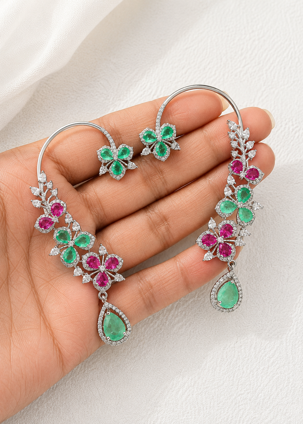 Close-up of Verdelle CZ Floral Ear Cuff Set showcasing emerald green and ruby pink floral stones with cubic zirconia detailing.