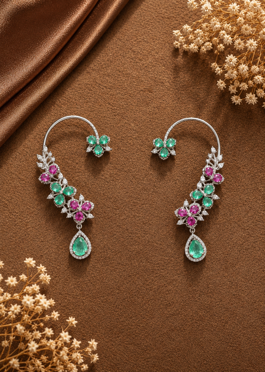 Verdelle CZ Floral Ear Cuff Set with emerald green and ruby pink floral stones displayed on a luxury flat lay background.