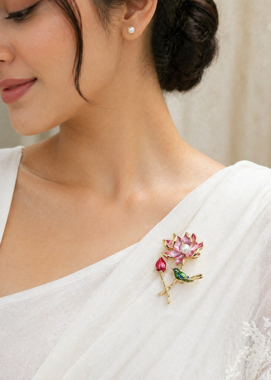 Woman wearing a white saree with a floral brooch 