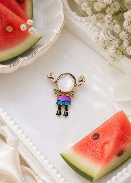 Small figurine of a girl brooch with a watermelon slice on a decorative plate
