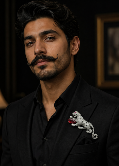 Man wearing a black suit with a decorative panther brooch