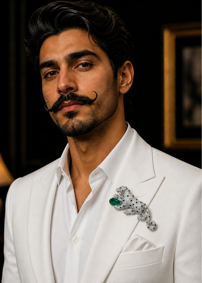 Man in a white suit with a decorative tiger brooch, set against a dark background.