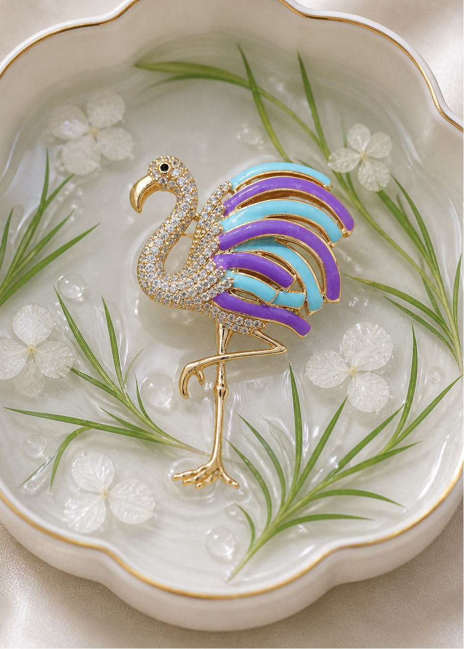 Colorful flamingo brooch on a decorative plate