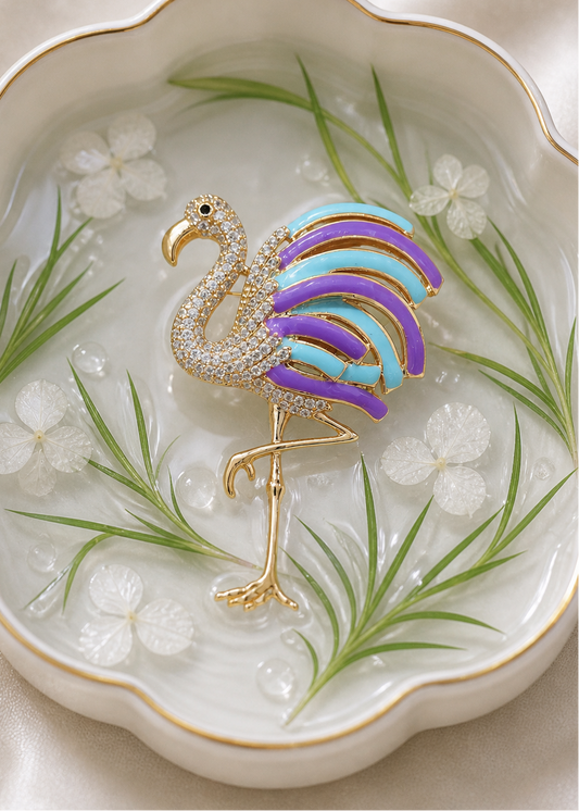 Colorful flamingo brooch on a decorative plate