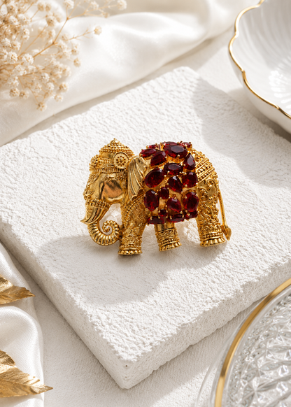 Regal Ruby Elephant Brooch displayed in a studio flat lay