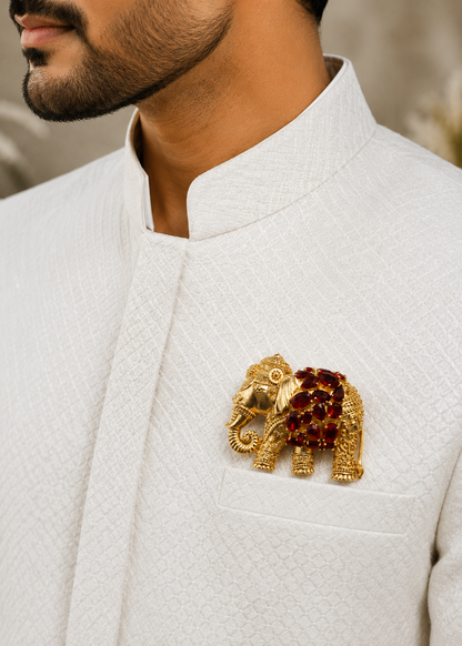 Regal Ruby Elephant Brooch worn on a white jacket by a man