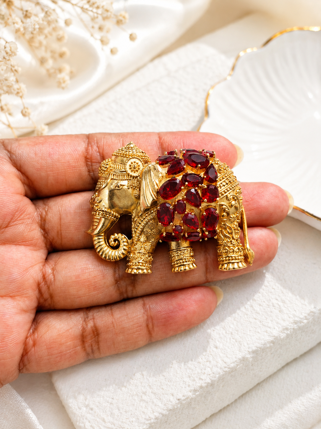 Regal Ruby Elephant Brooch shown close up in hand