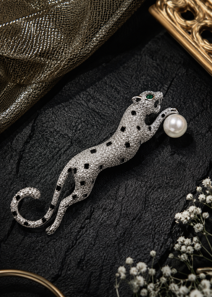 Midnight Pearl Panther Brooch displayed in a dark studio flat lay