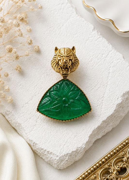 Emerald Tiger Carved-Stone Brooch displayed in a light studio flat lay