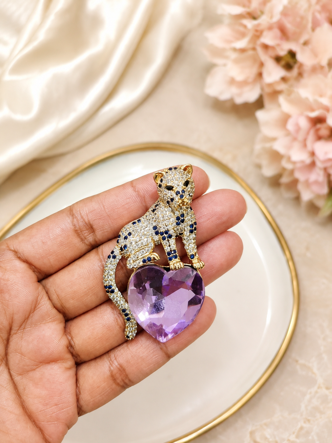 Lavender Heart Panther Brooch shown close up in hand