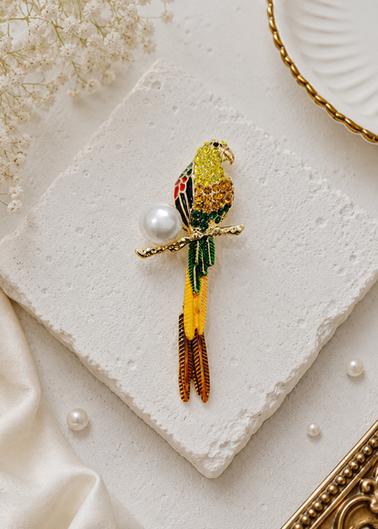 Golden Parrot Pearl Brooch displayed in a light studio flat lay