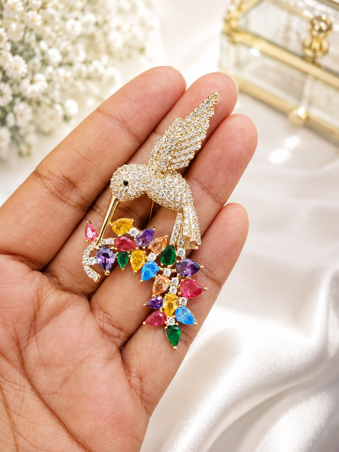 Rainbow Hummingbird Crystal Brooch shown close up in hand