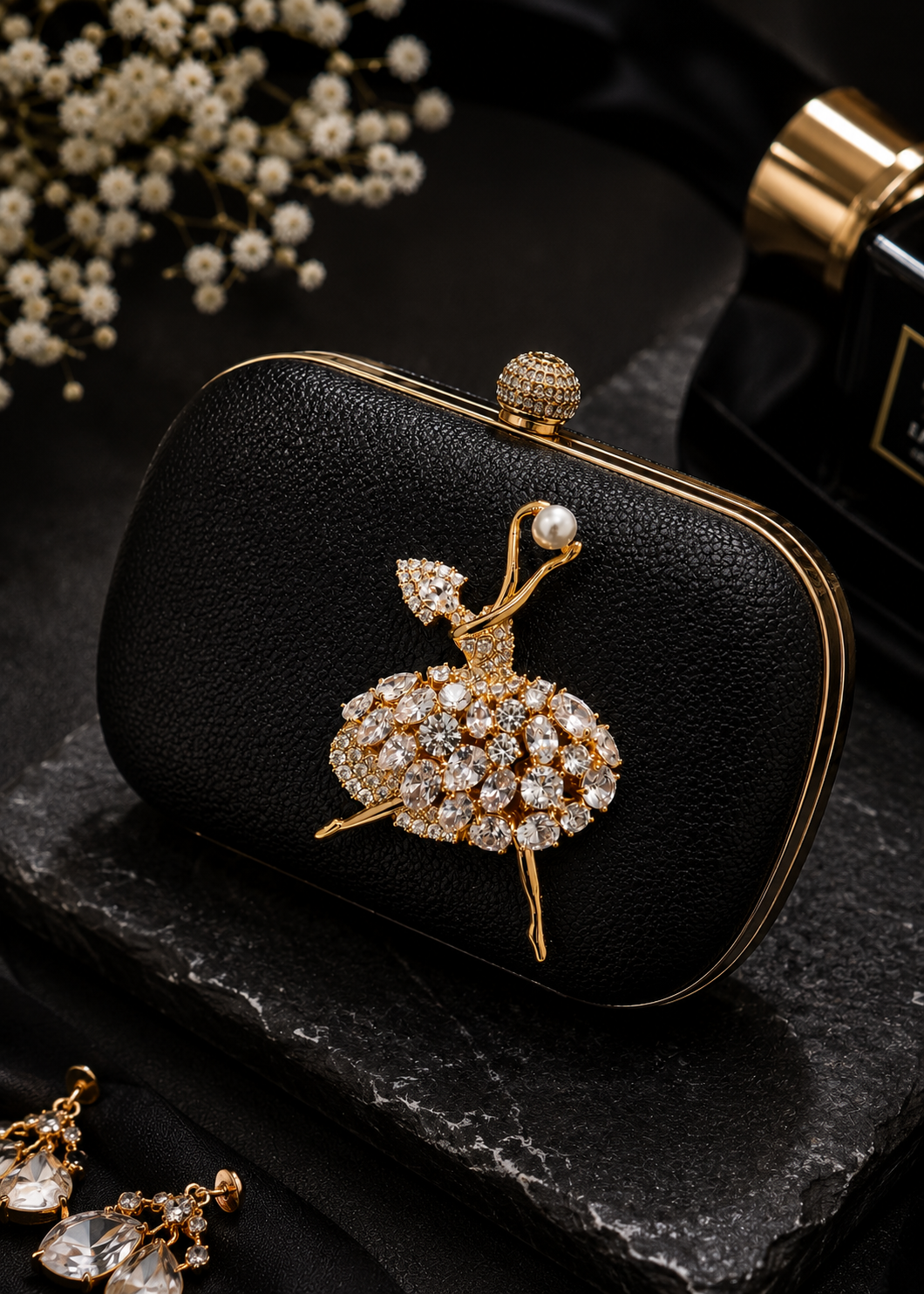 Pearl Pirouette Crystal Dancer Brooch displayed on a black evening clutch