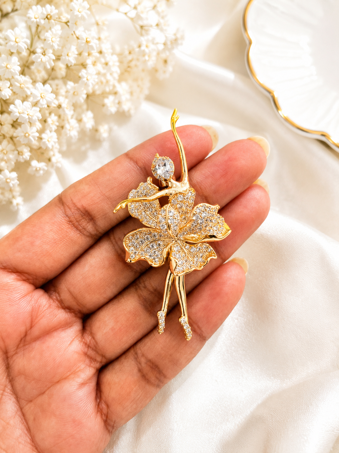 Golden Bloom Ballerina Brooch shown close up in hand