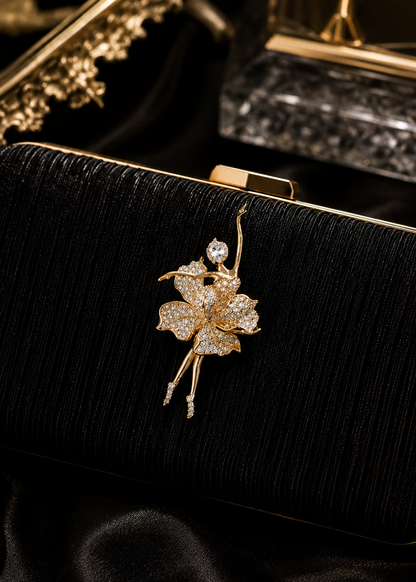 Golden Bloom Ballerina Brooch displayed on a black evening clutch