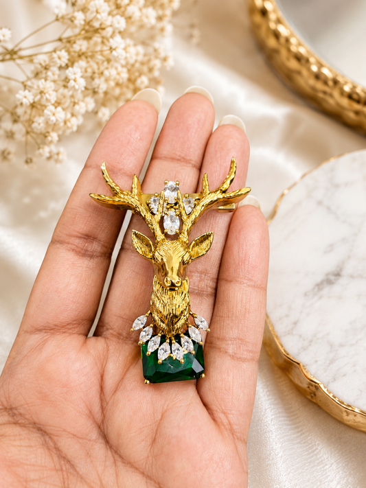 Emerald Crown Stag Crystal Brooch shown close up in hand