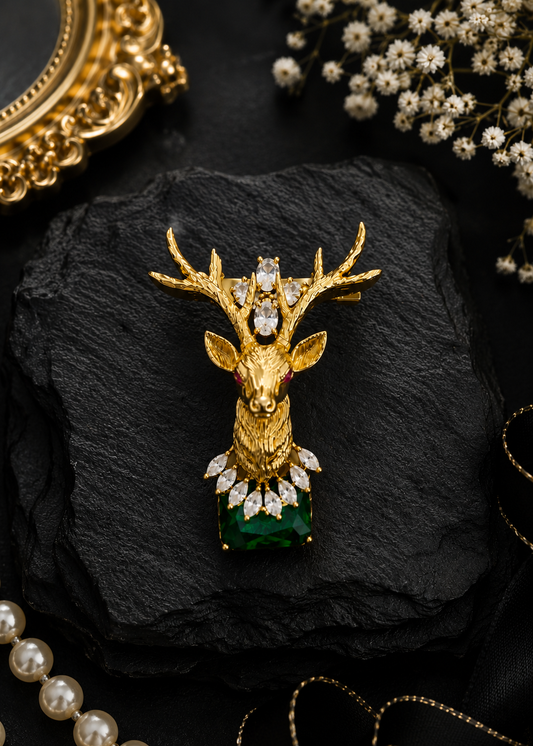 Emerald Crown Stag Crystal Brooch displayed in a dark studio flat lay