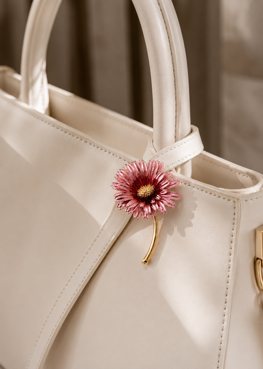 Blush Daisy Stem Brooch styled on a white handbag