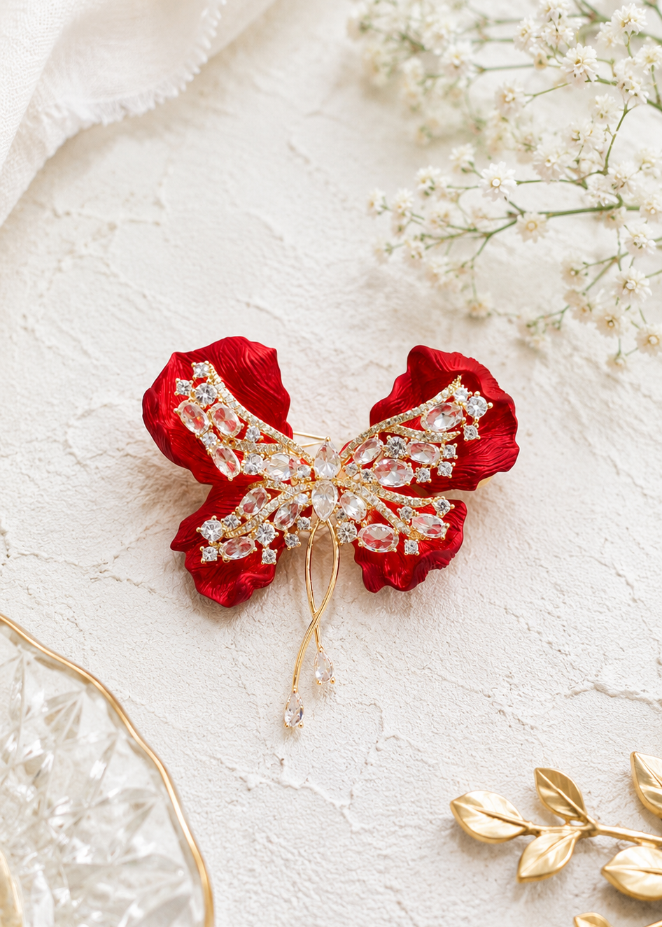 Crimson Bow Butterfly Brooch displayed in a light studio flat lay