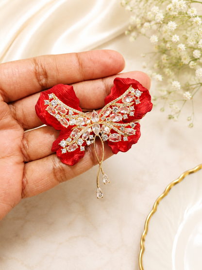 Crimson Bow Butterfly Brooch shown close up in hand