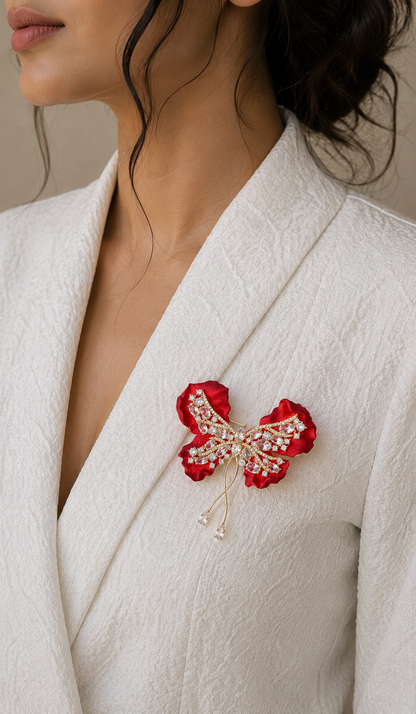 Crimson Bow Butterfly Brooch worn on a white blazer