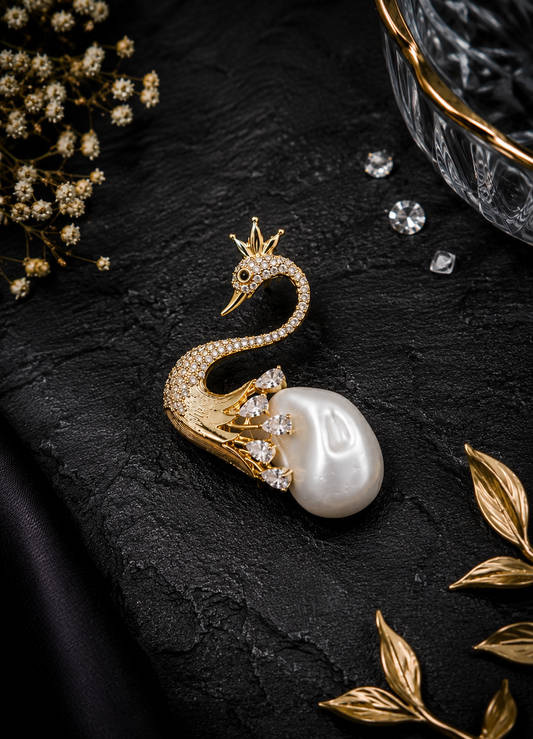 Pearl Swan Crystal Brooch displayed in a dark studio flat lay