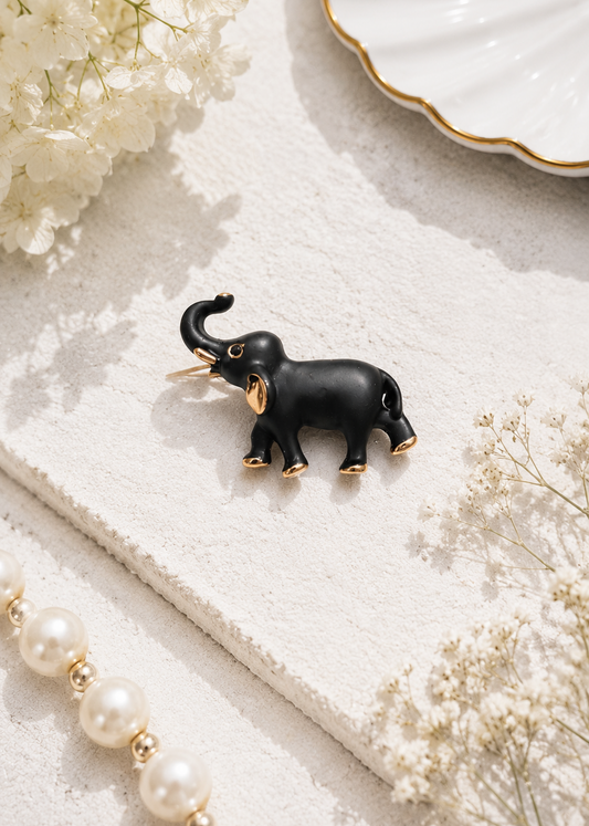 Midnight Charm Elephant Brooch displayed in a light studio flat lay