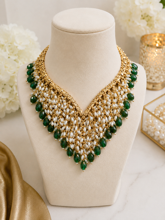 Emerald Cascade Pearl Necklace Set displayed on a jewellery bust