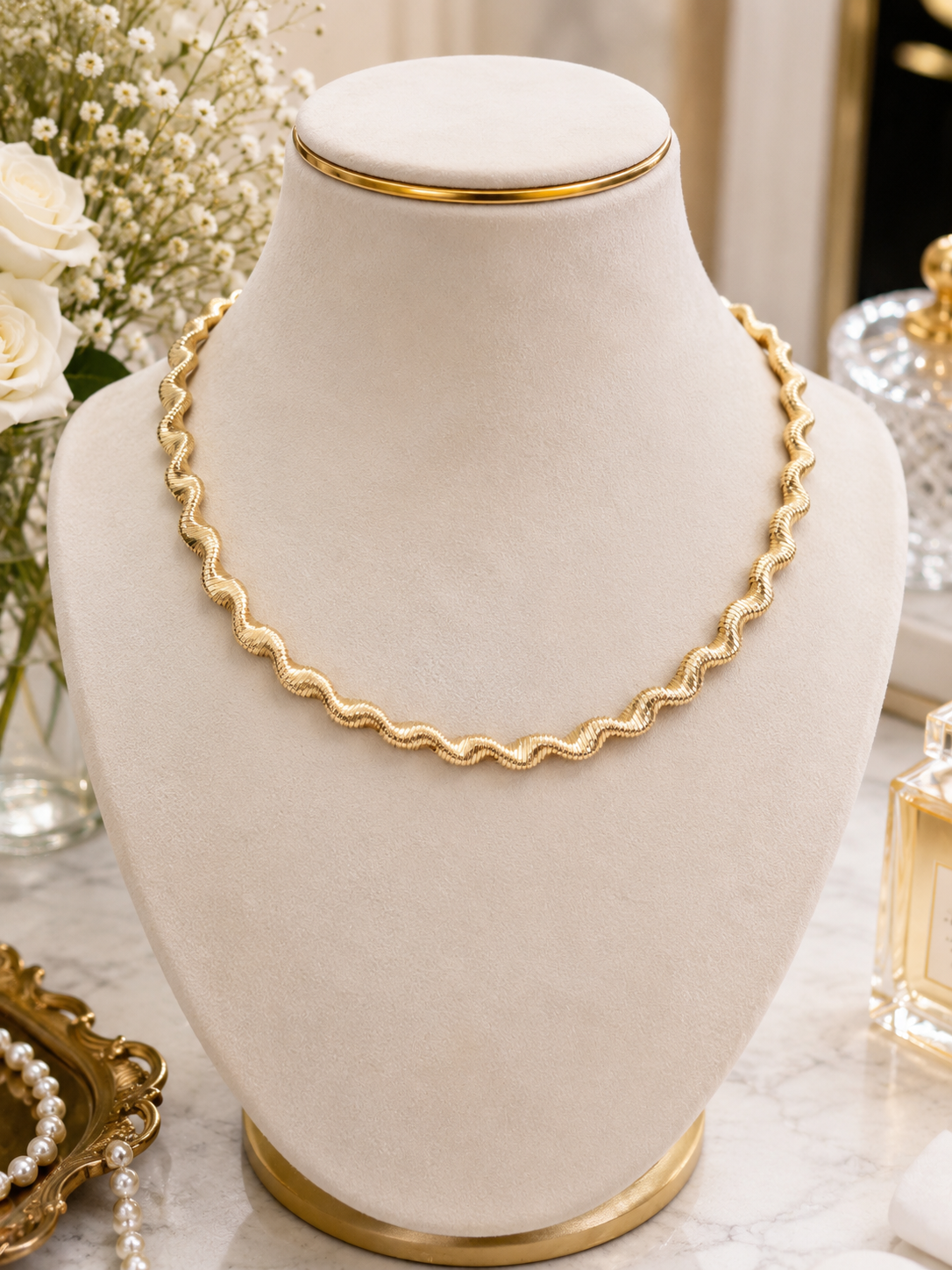 Golden Ripple Chain Necklace displayed on a jewellery bust