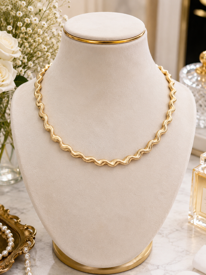 Golden Ripple Chain Necklace displayed on a jewellery bust