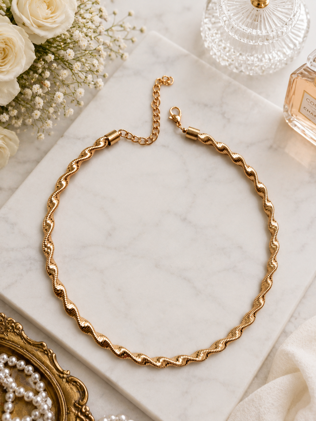 Golden Ripple Chain Necklace shown in a styled flat lay