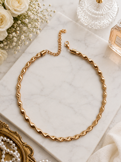 Golden Ripple Chain Necklace shown in a styled flat lay
