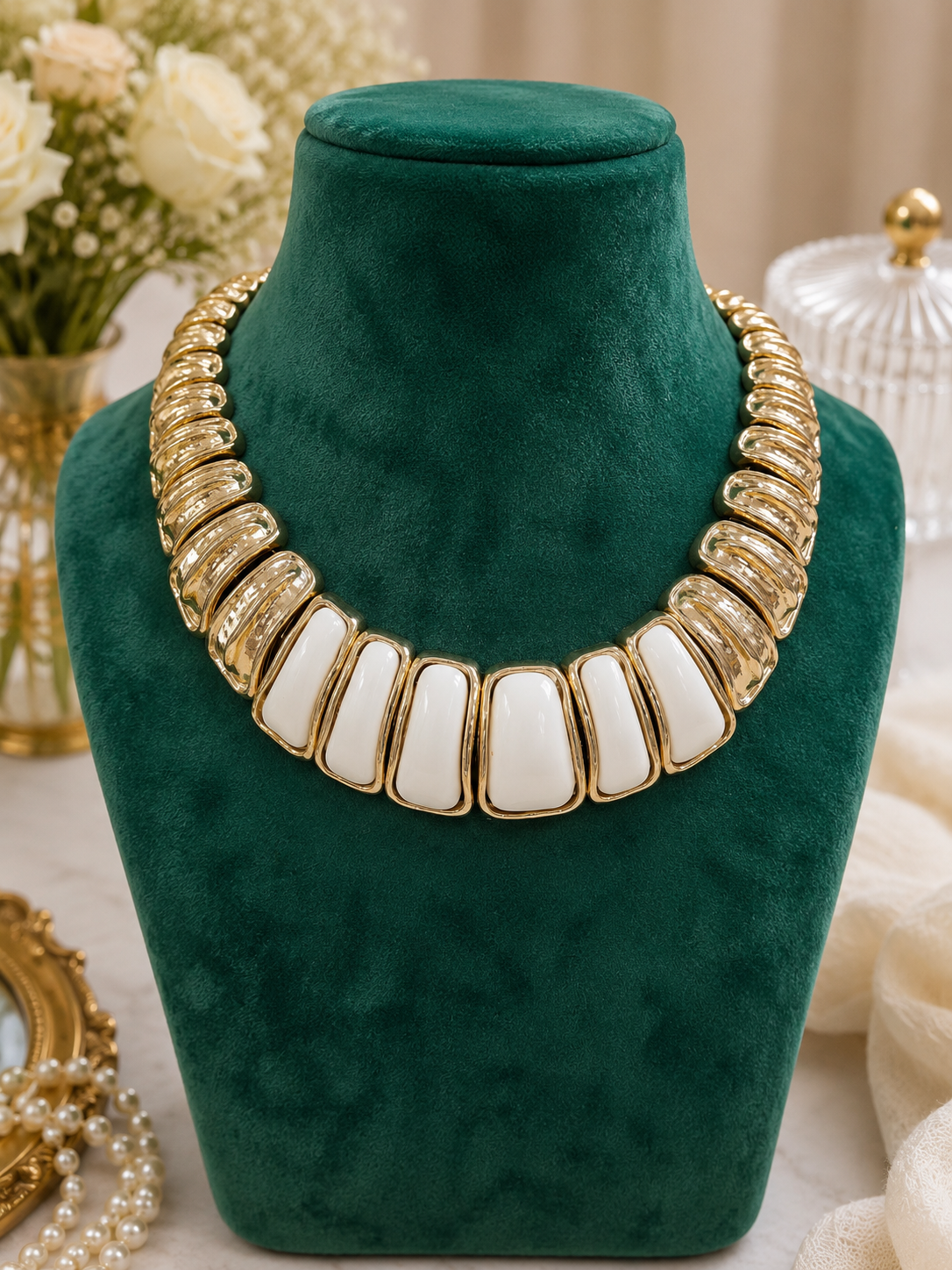 Ivory Crest Enamel Necklace displayed on a green jewellery bust