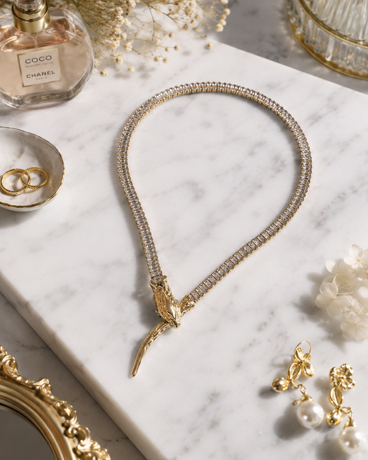 Golden Cascade Crystal Necklace shown in a styled flat lay