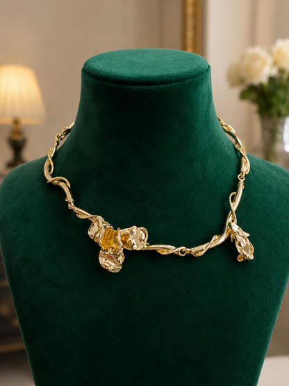 Golden Vine Floral Necklace displayed on a green jewellery bust
