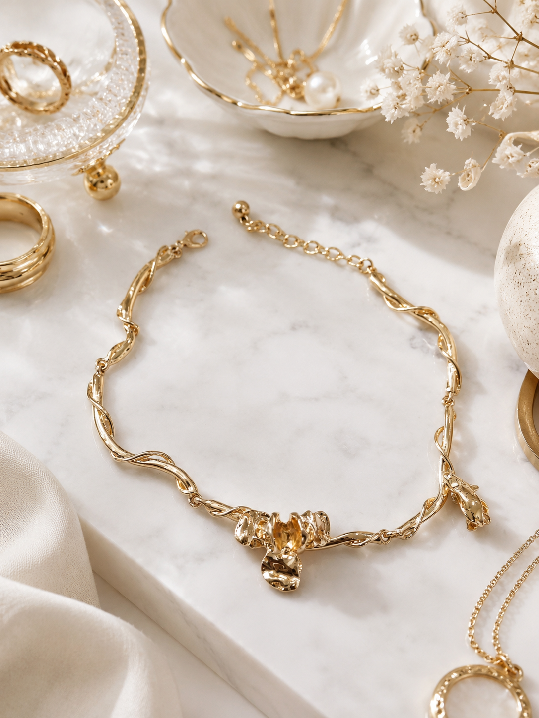 Golden Vine Floral Necklace shown in a styled flat lay