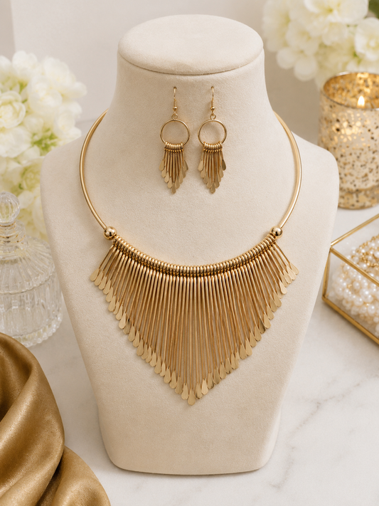 Aurora Gold Statement Necklace Set displayed on jewellery bust with matching gold fringe earrings