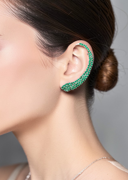 Model wearing Celeste Green Crystal Ear Cuff with sparkling green crystals in a silver-tone ear climber design