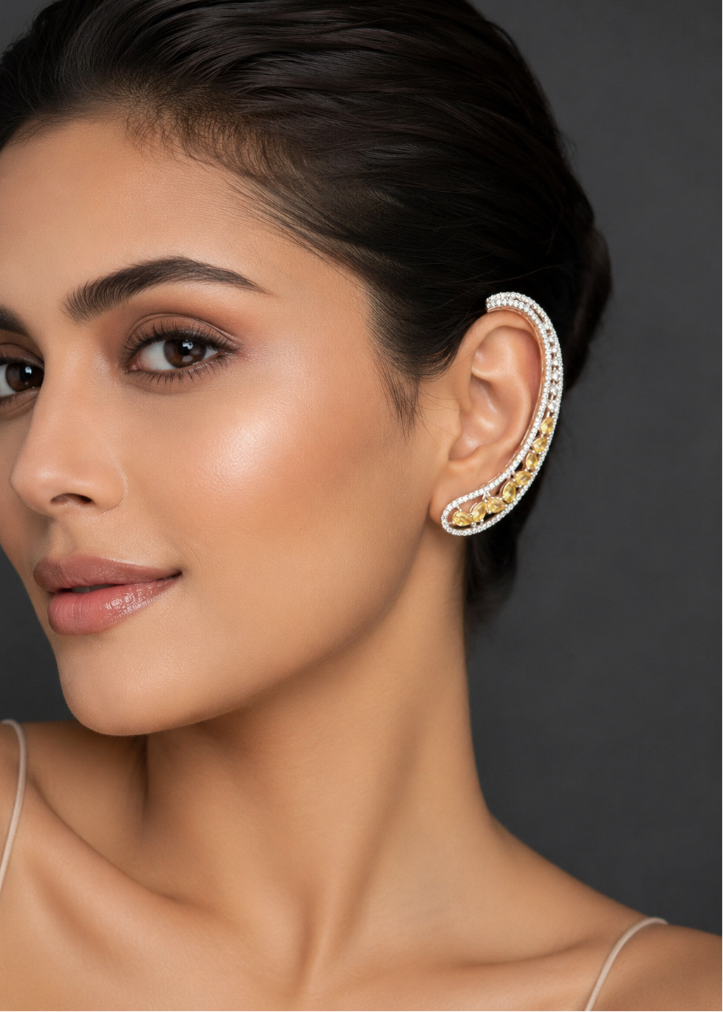 Model wearing Celeste Yellow Stone Ear Cuff with silver-tone setting and yellow crystal stones