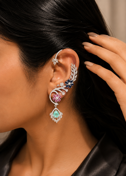 Model wearing Celestia CZ Floral Ear Cuff Set featuring sapphire blue, emerald green and ruby pink floral stones with sparkling cubic zirconia.